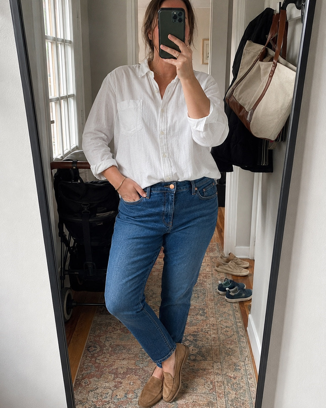 A woman wearing Ginger and Dandelion jeans in a mirror selfie